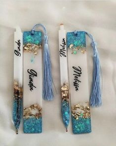 Decorative bookmarks with tassels and blue accents on a light background